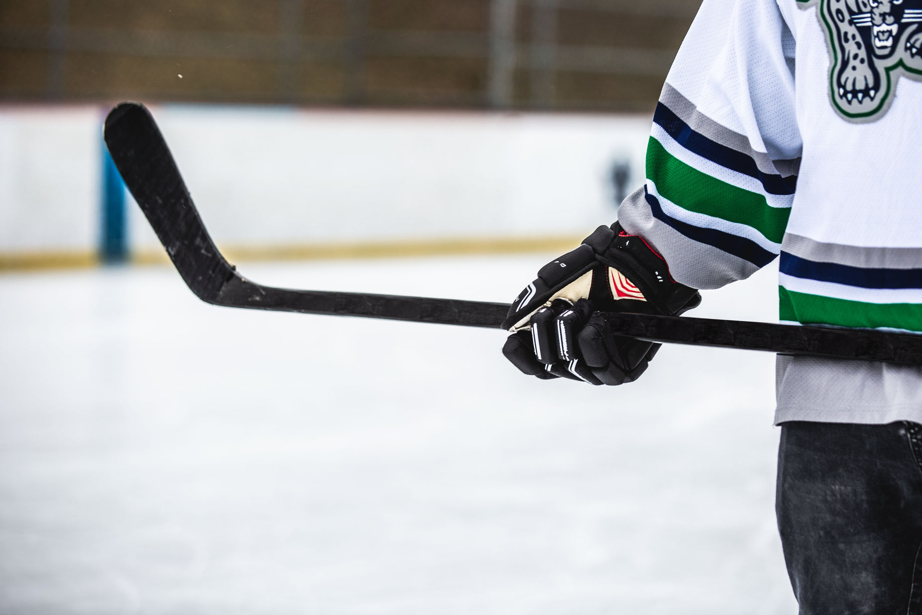 a person wearing a hockey jersey with a stick in hand