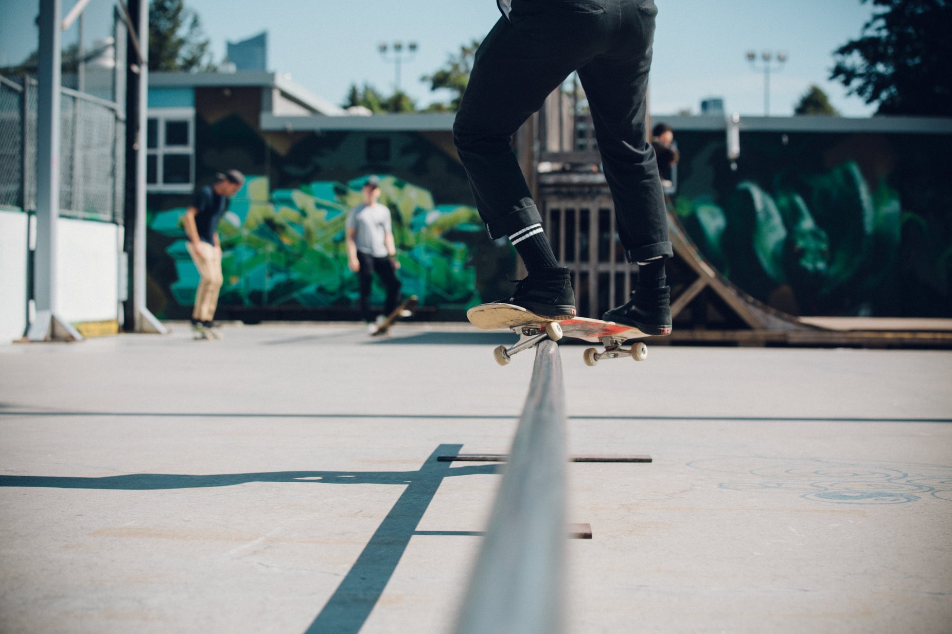 a skateboarder performs stunts in an outdoor park