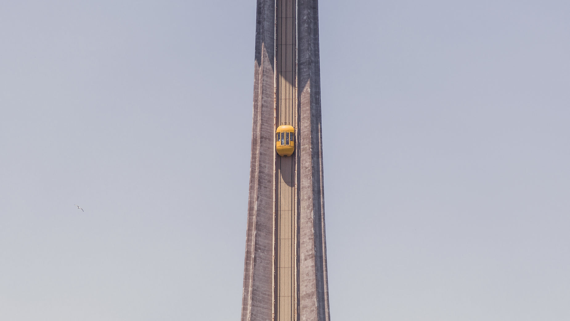 a large tower that has two clocks and a yellow one