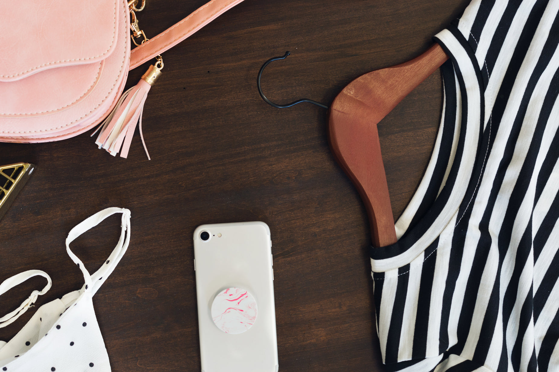 accessories on the table including a bag, purse and phone