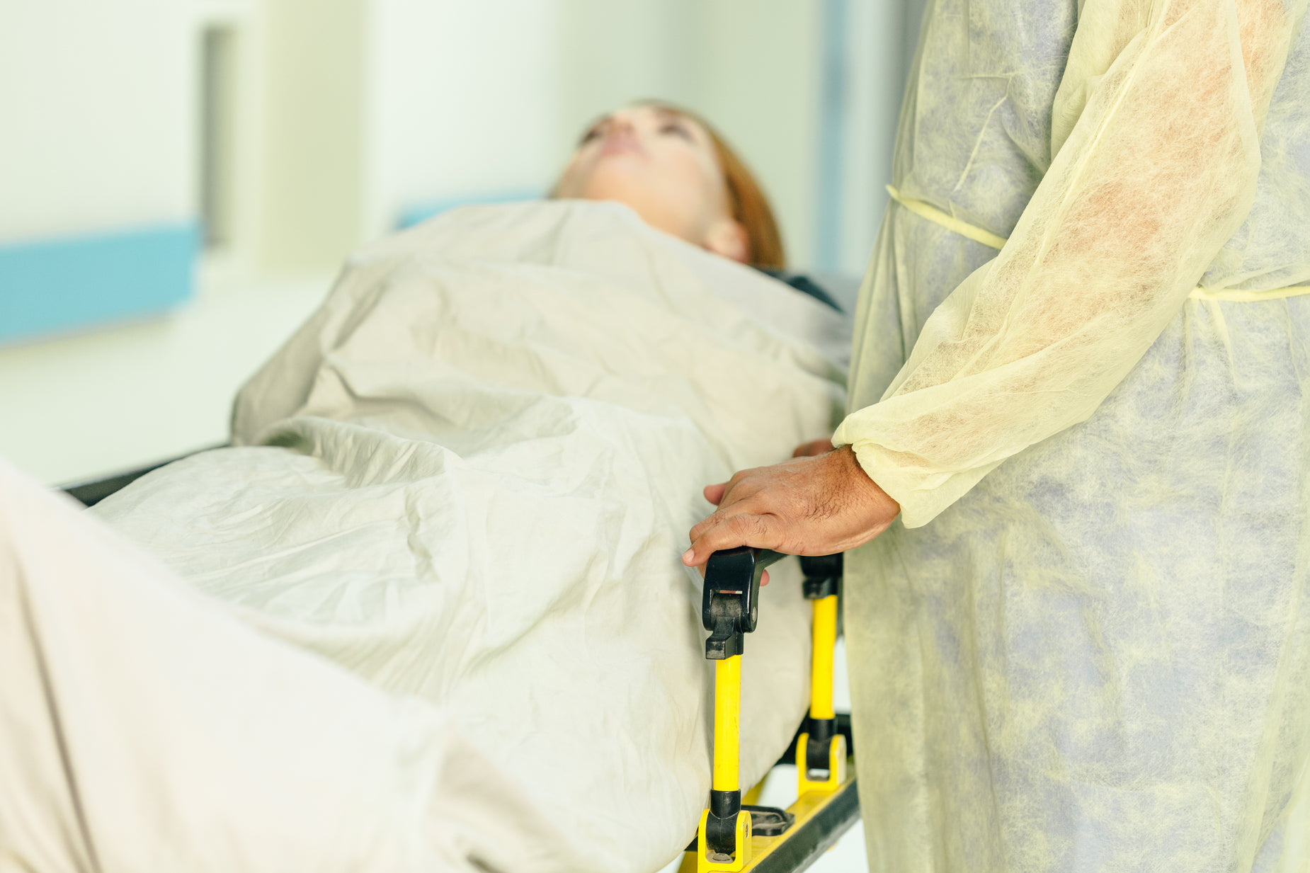 an older man with yellow walker is getting ready to board a patient