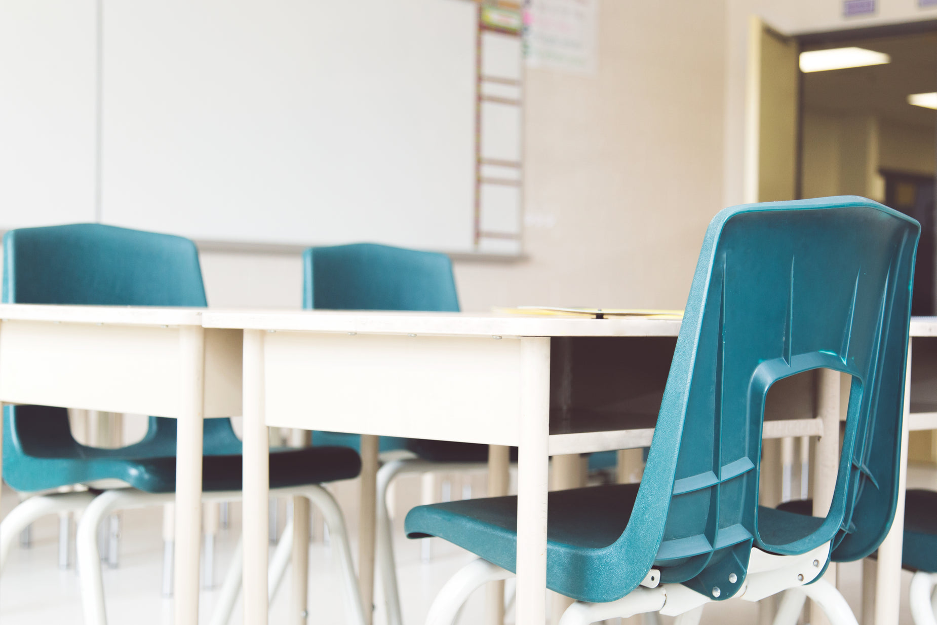 a po taken of a classroom setting with chairs and desk