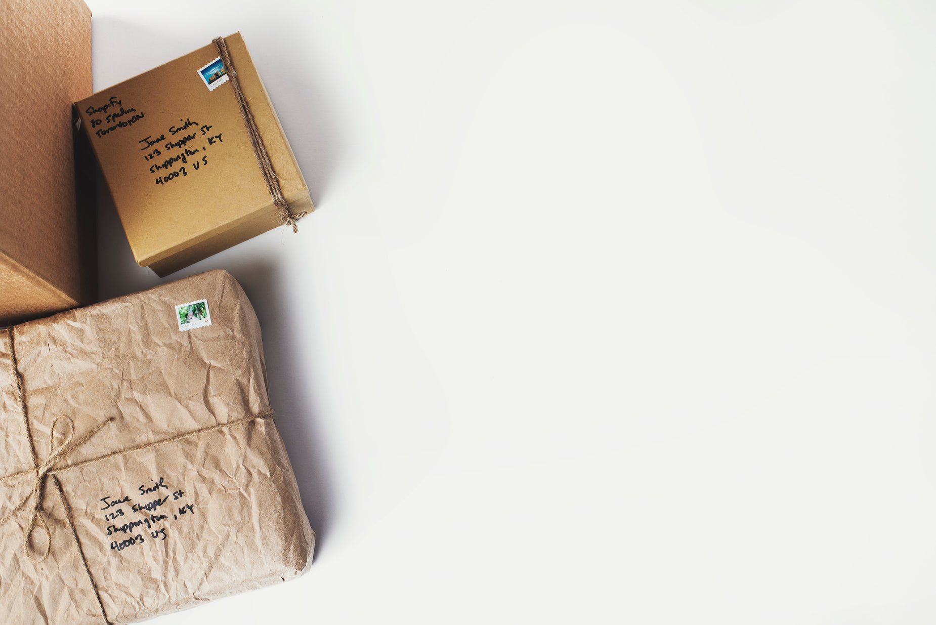 a wrapped package and a cardboard box on a white background