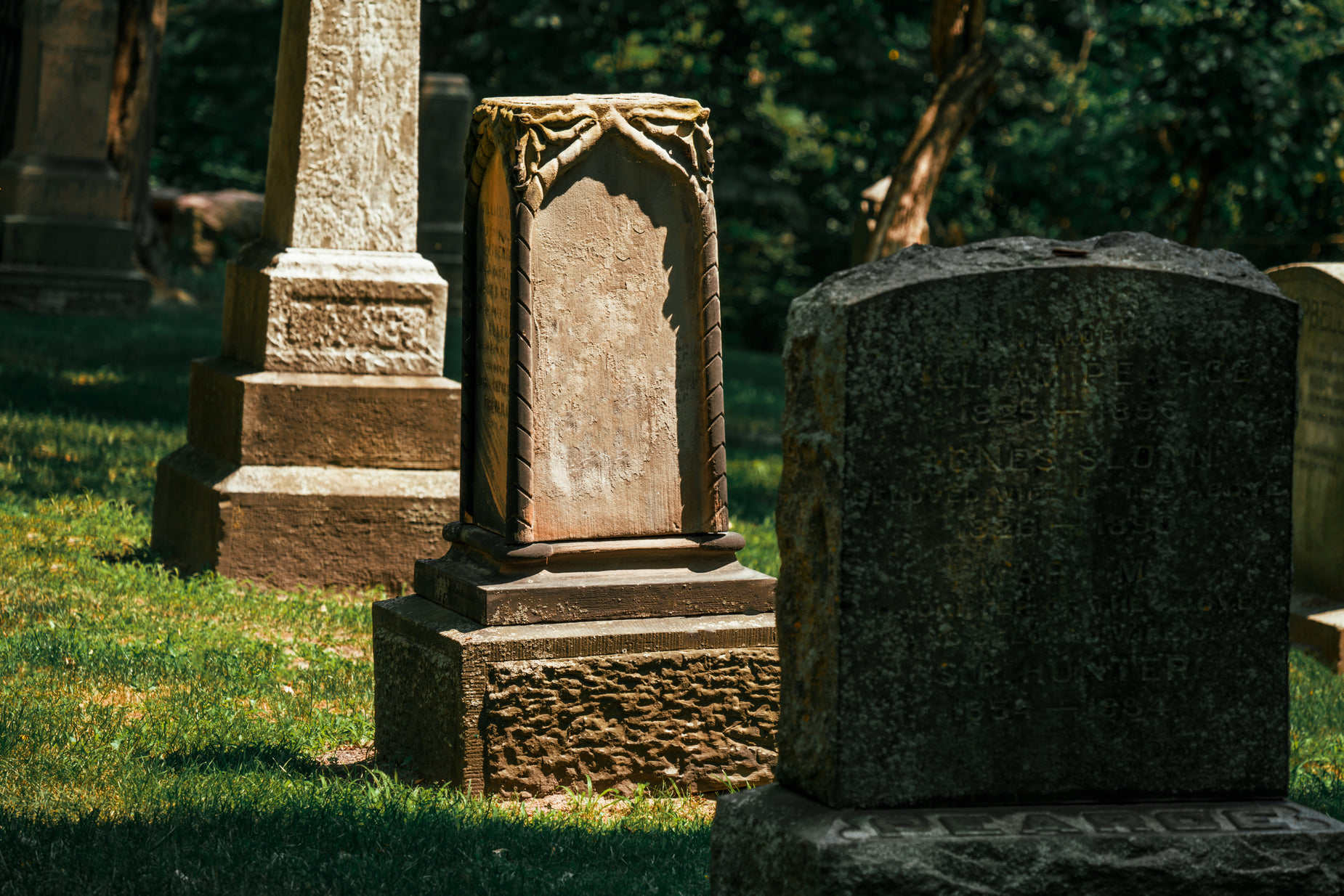 an old grave with a statue next to it