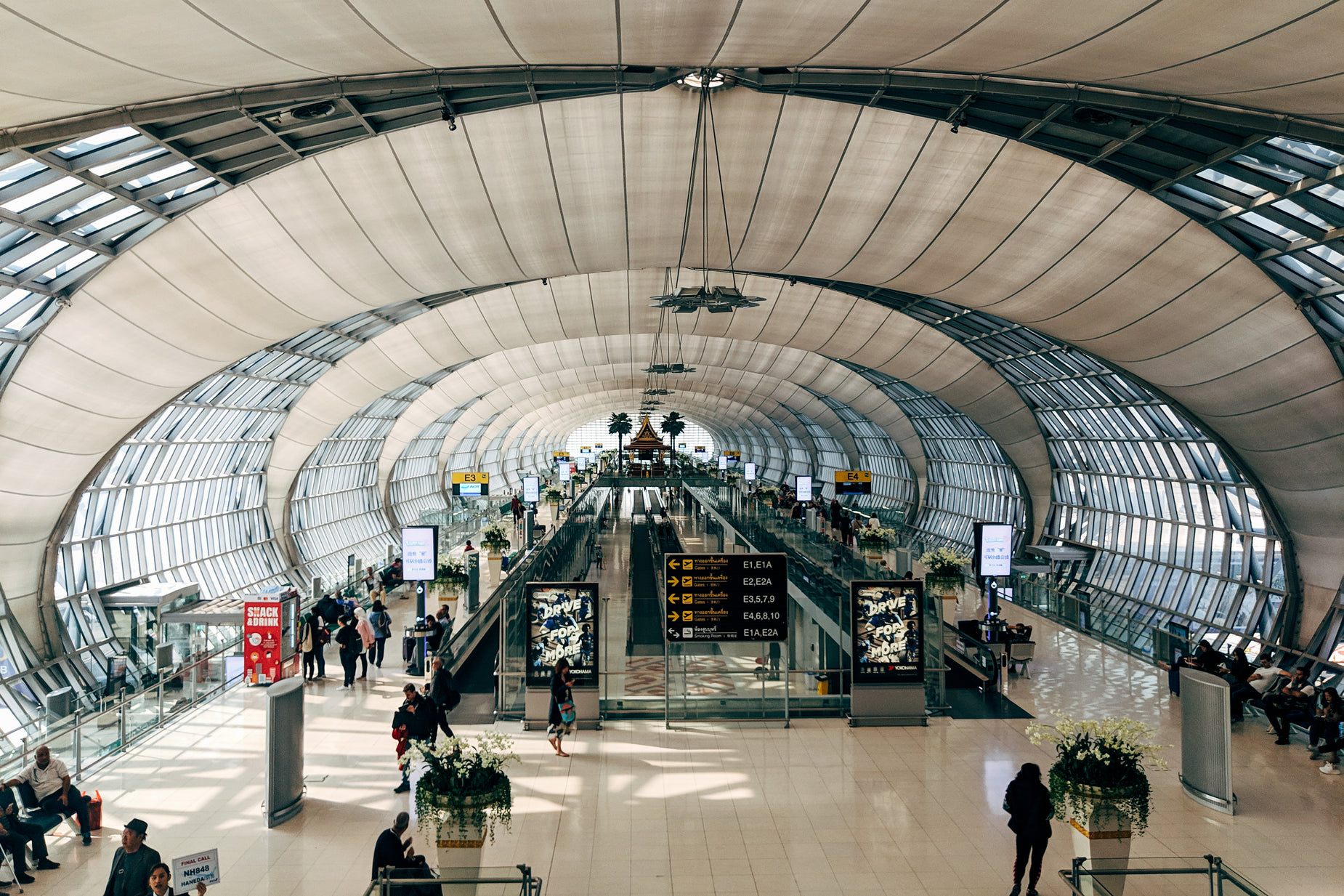 an overhead view of people standing at the bottom of a huge station