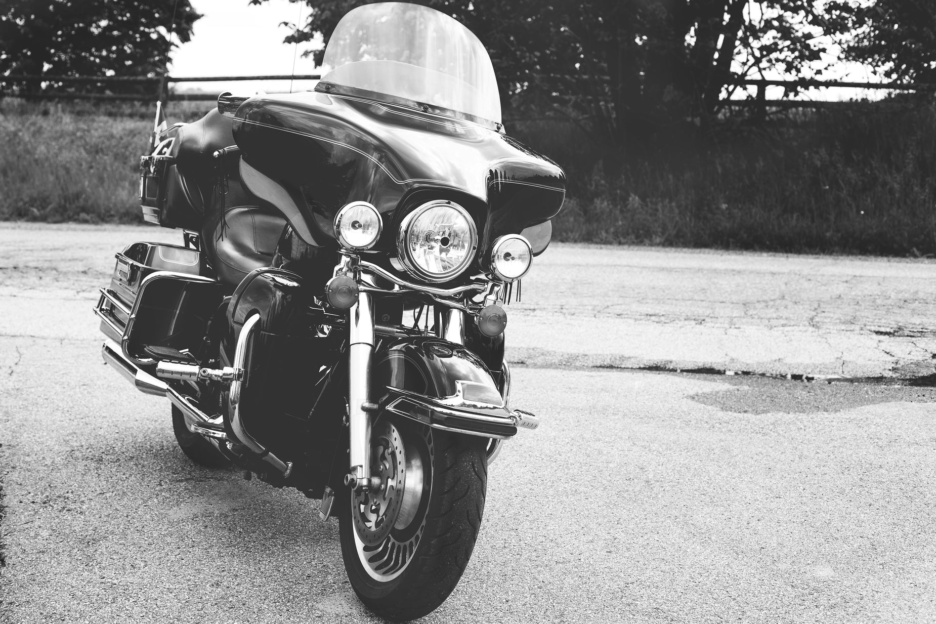 a black motorcycle is parked on the side of a road