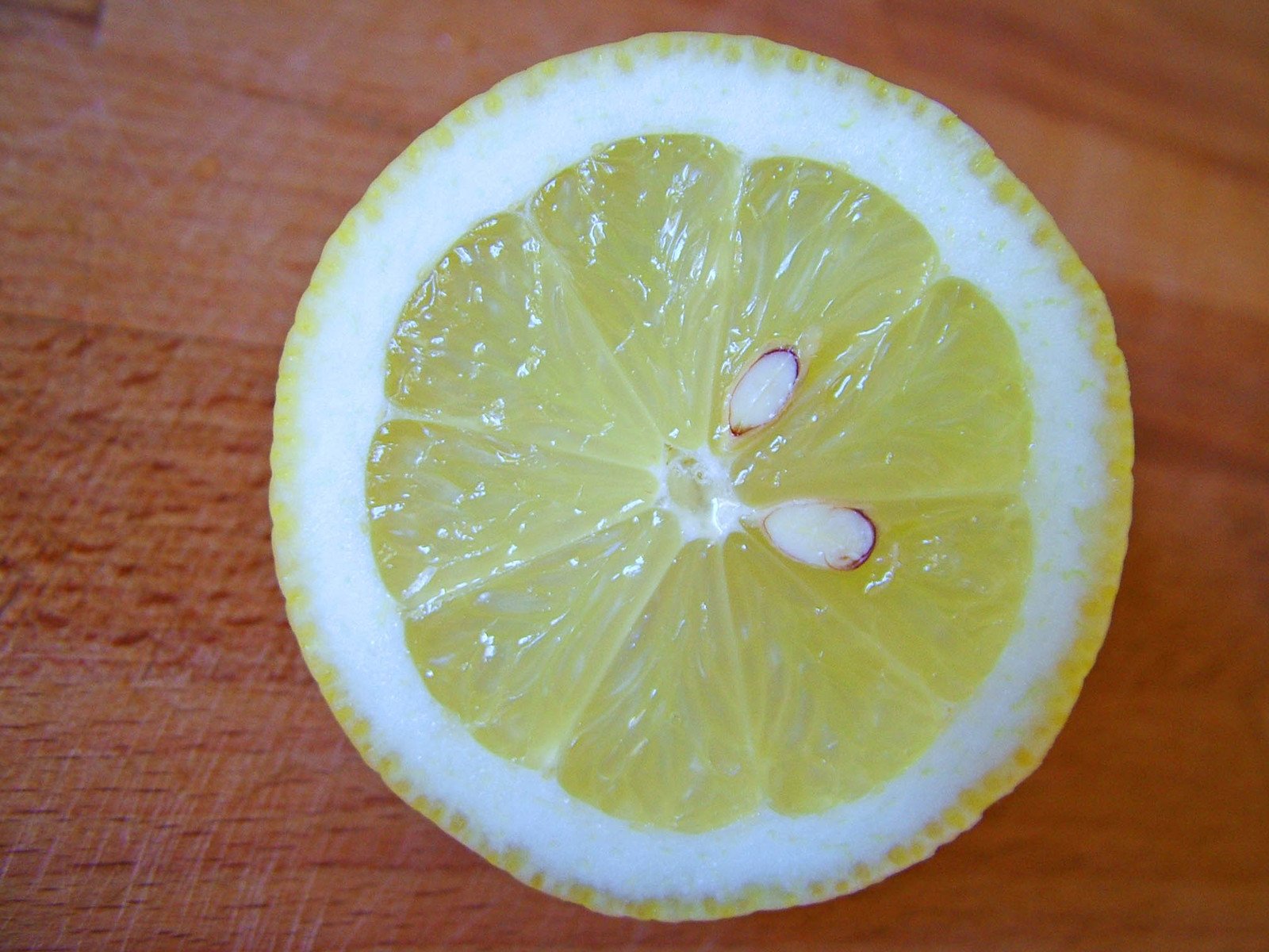the slice of a lemon is lying on the surface