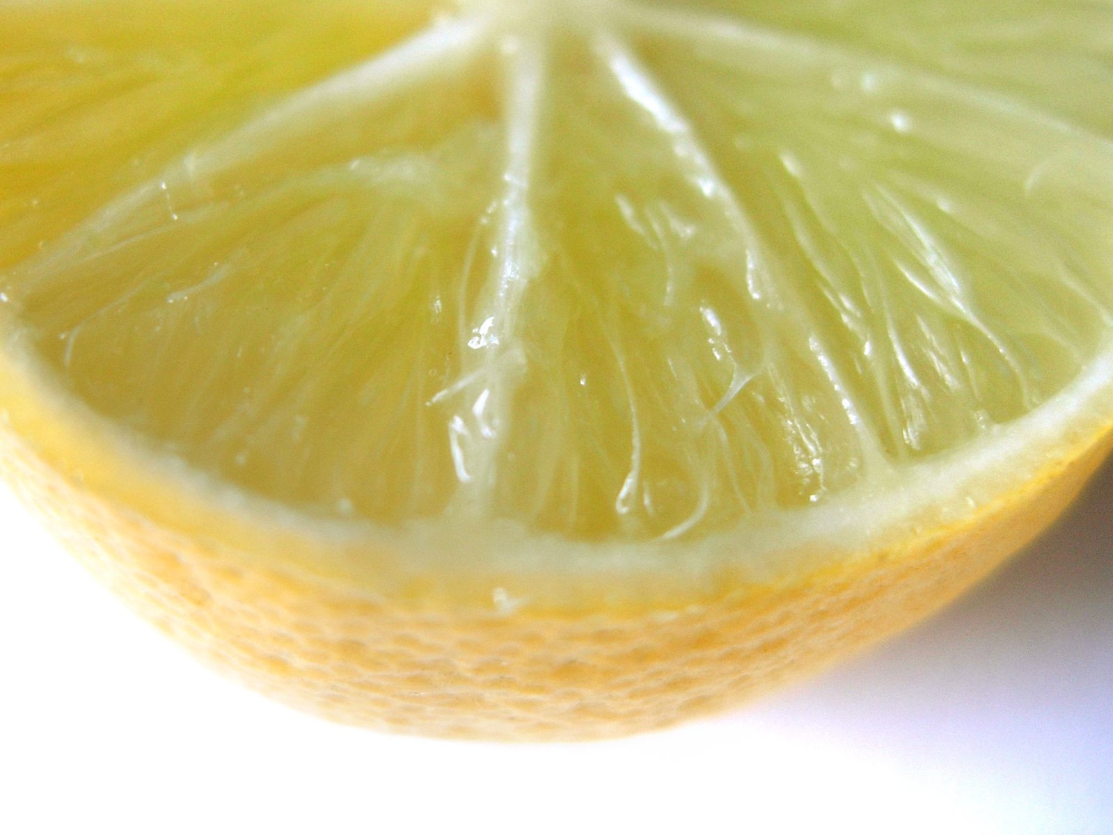 an extreme close up of a lime fruit sliced in half