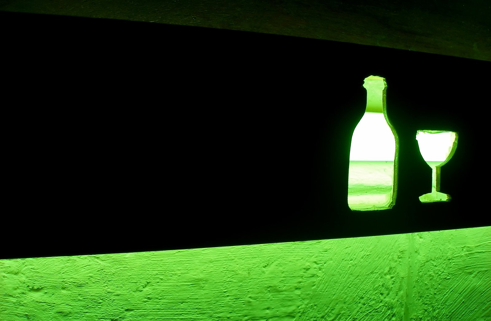 a bottle and glass are visible in the wall