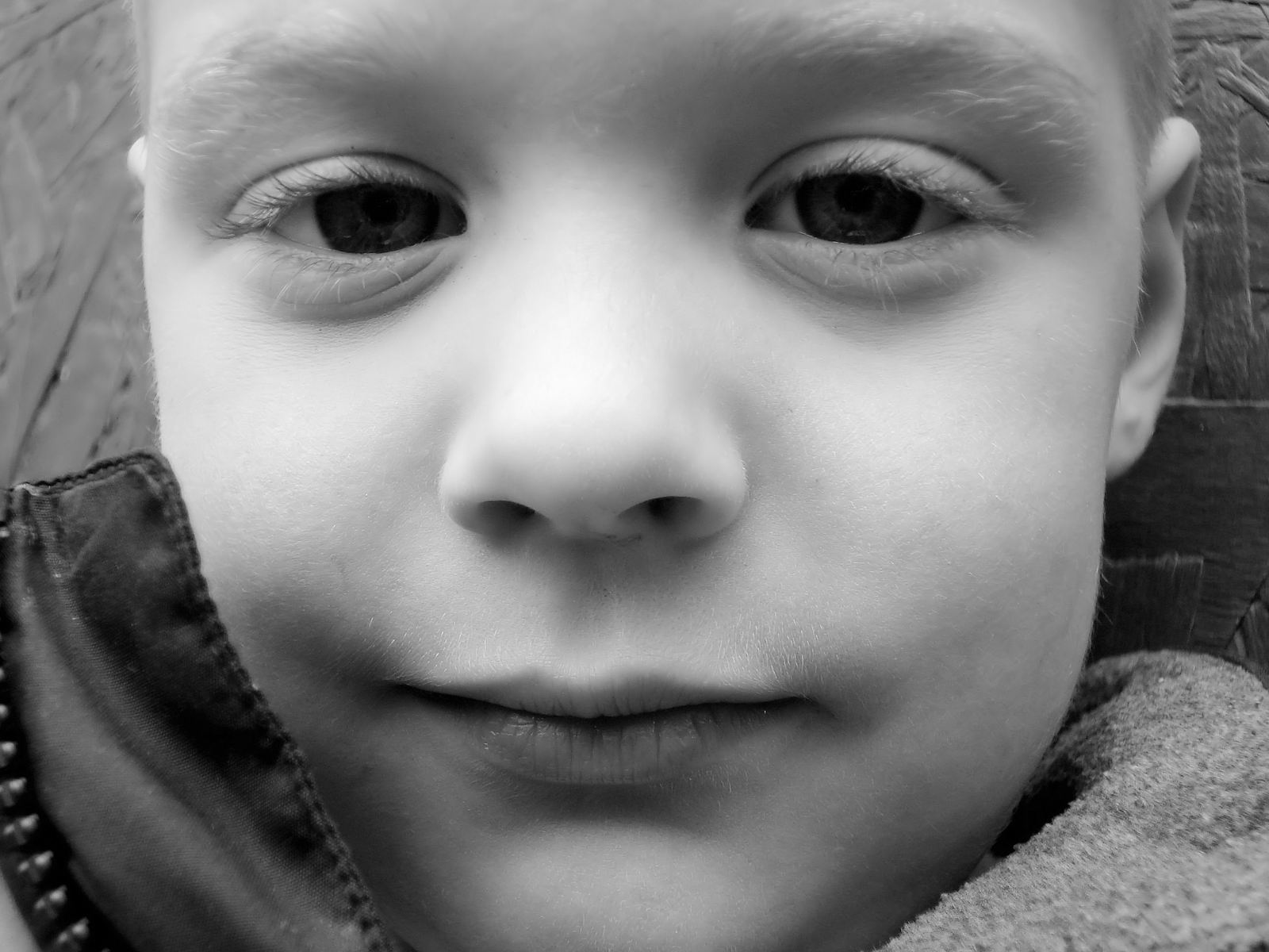 a little boy who is looking into the camera