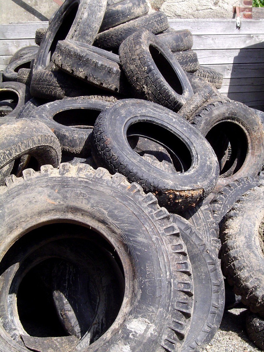 a pile of dirty old tires and wheels
