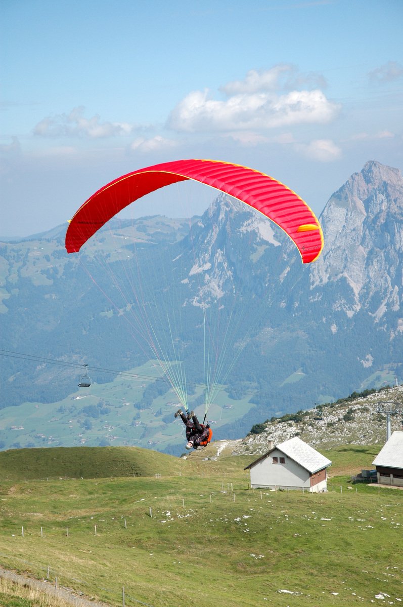 a person is para - sailing over a mountain range