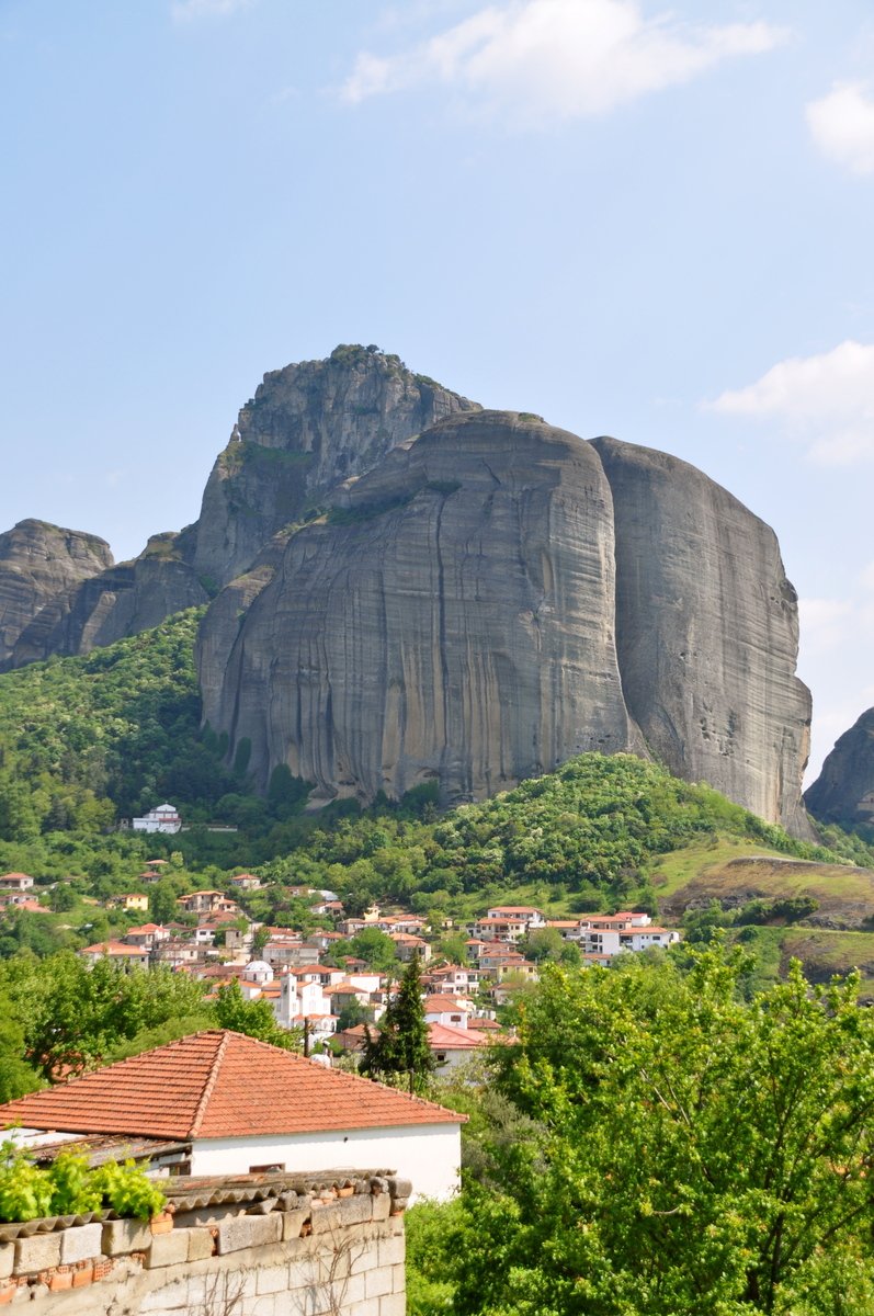 a small town with mountains in the background