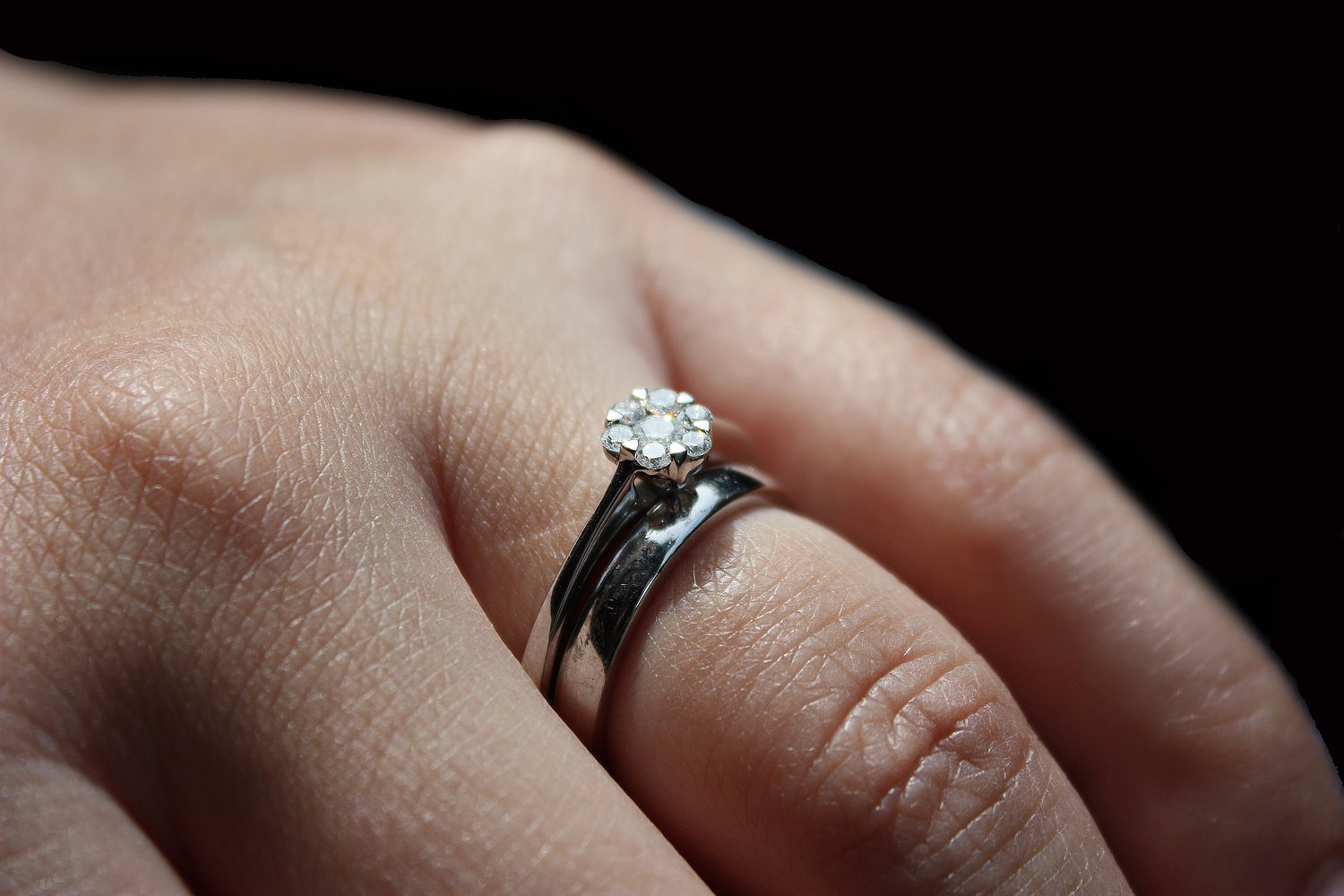 a close up po of someone's hand with a diamond ring