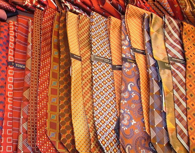 many different colored ties are lined up in a row
