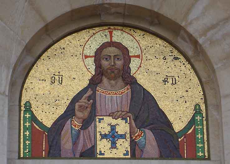 stained glass window of jesus in the center of a wall
