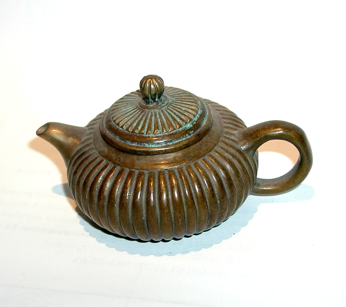 this is a tea pot that looks like a ribbed tea pot