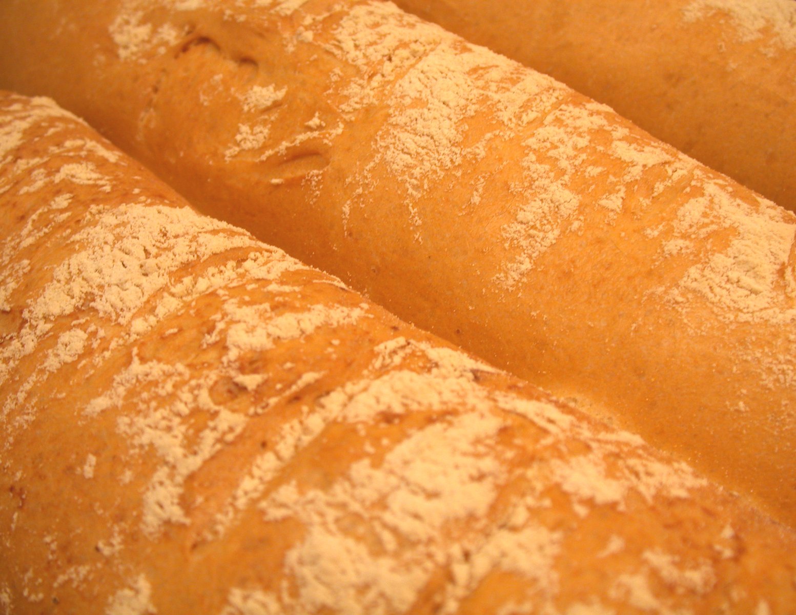 three loaves of bread that are lined up