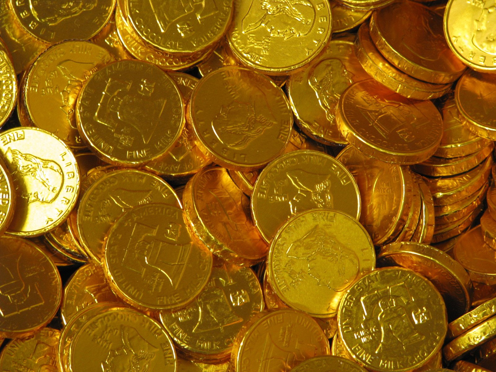 coins on a pile with one gold coin in the middle