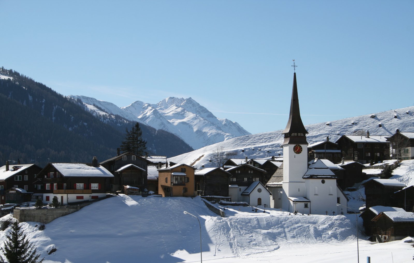 the town is surrounded by snow covered mountains