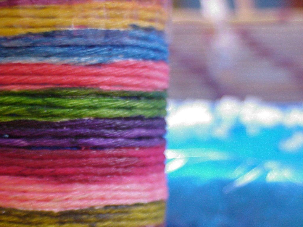 colorful yarn that has been picked up from the container