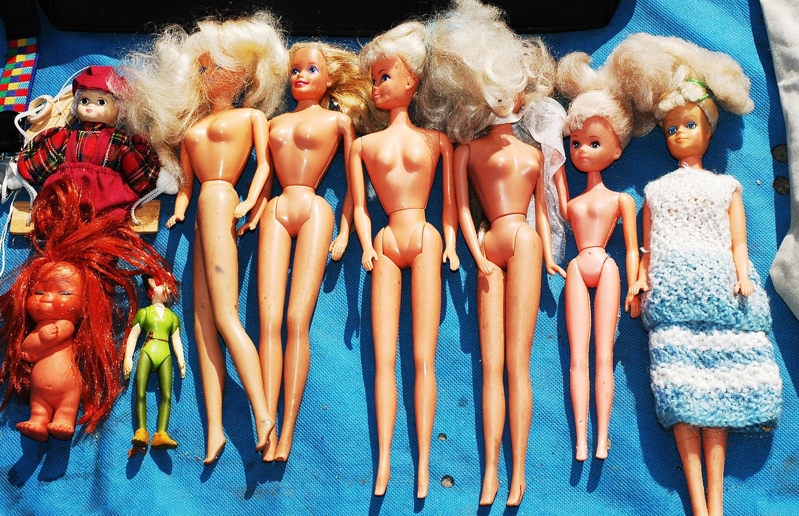 a group of various barbie dolls lined up next to each other