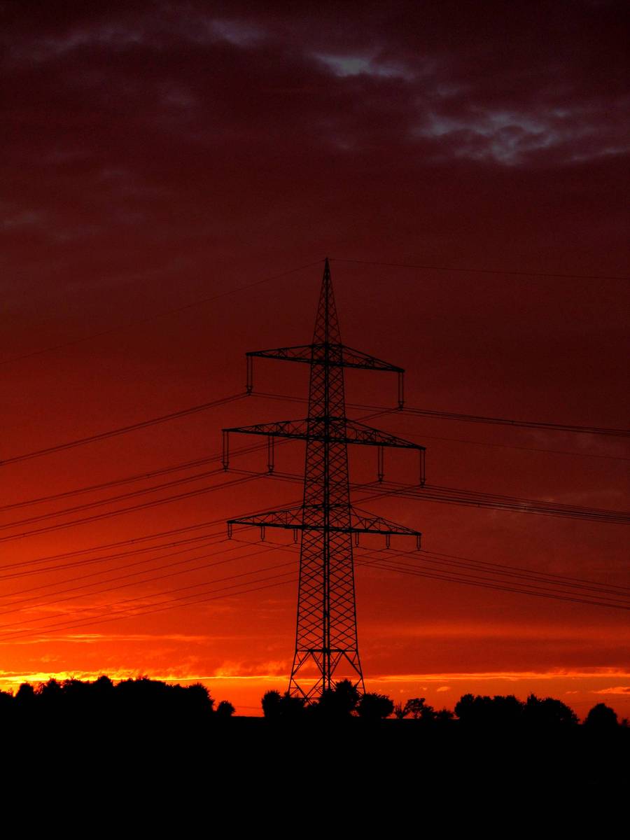 the sky and telephone poles silhouetted against the sun