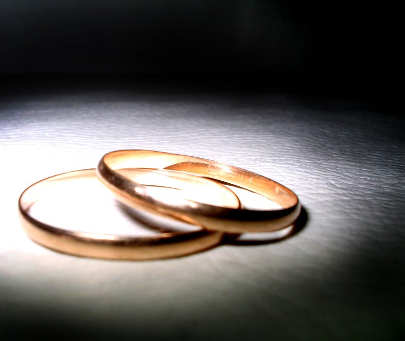 three wedding rings on top of a white table