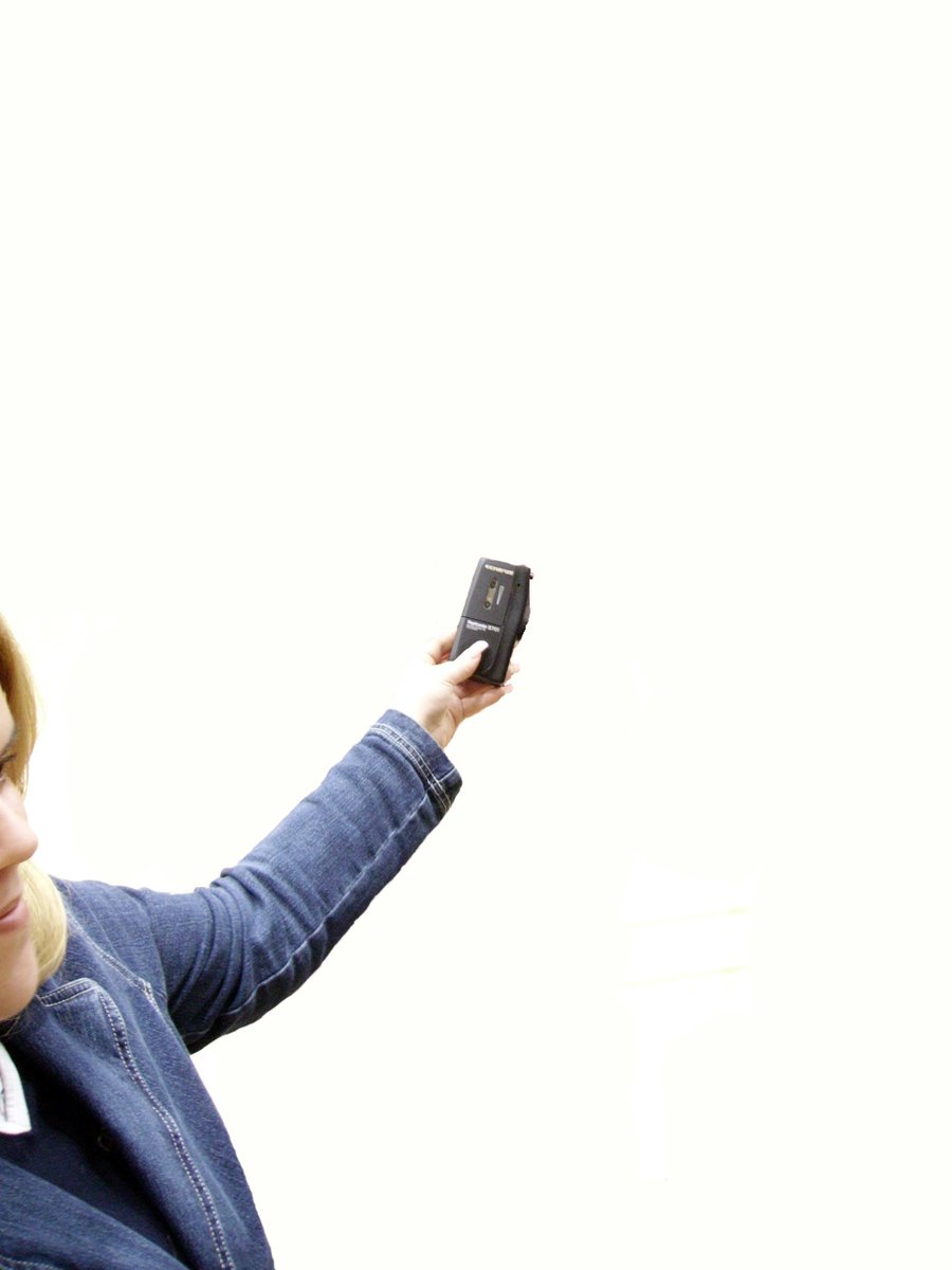 a woman holding onto a cell phone and making a face