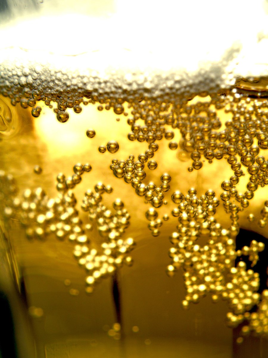 bubbles floating on the surface of a glass
