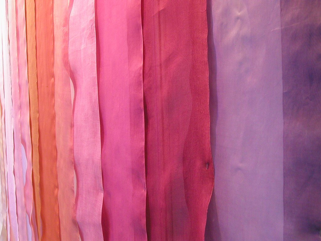 a multi colored line of cloth hanging from a ceiling