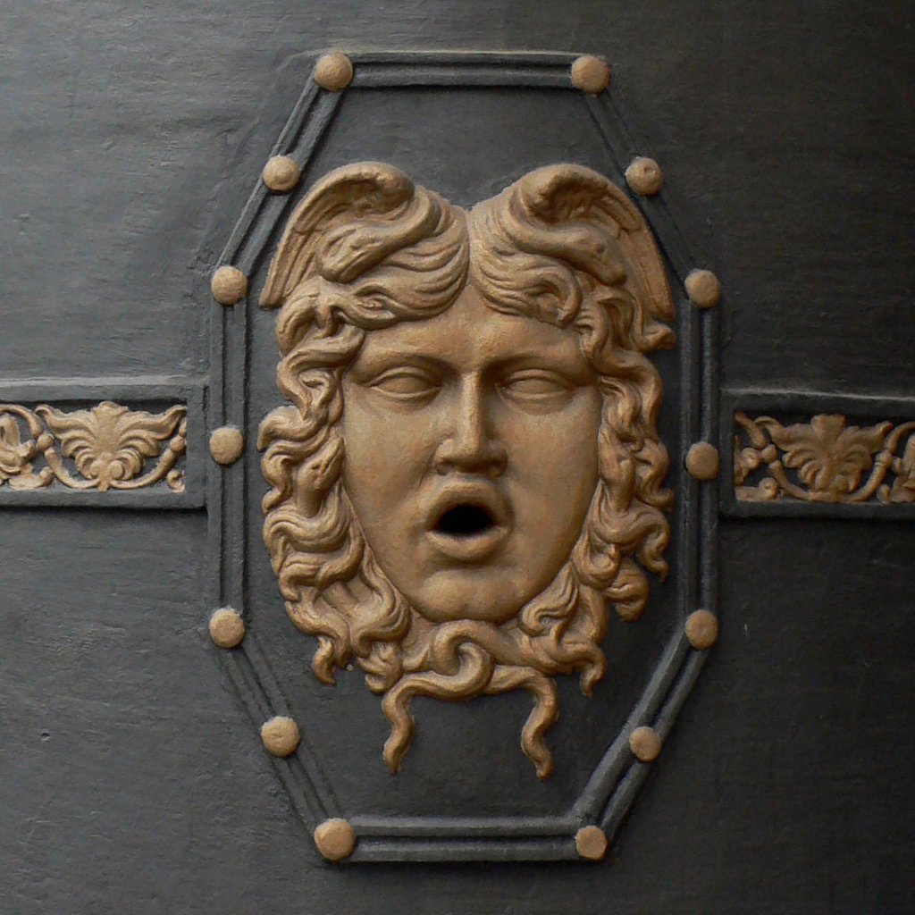 an artistic wall decoration of a face with eyes closed and mouth wide open