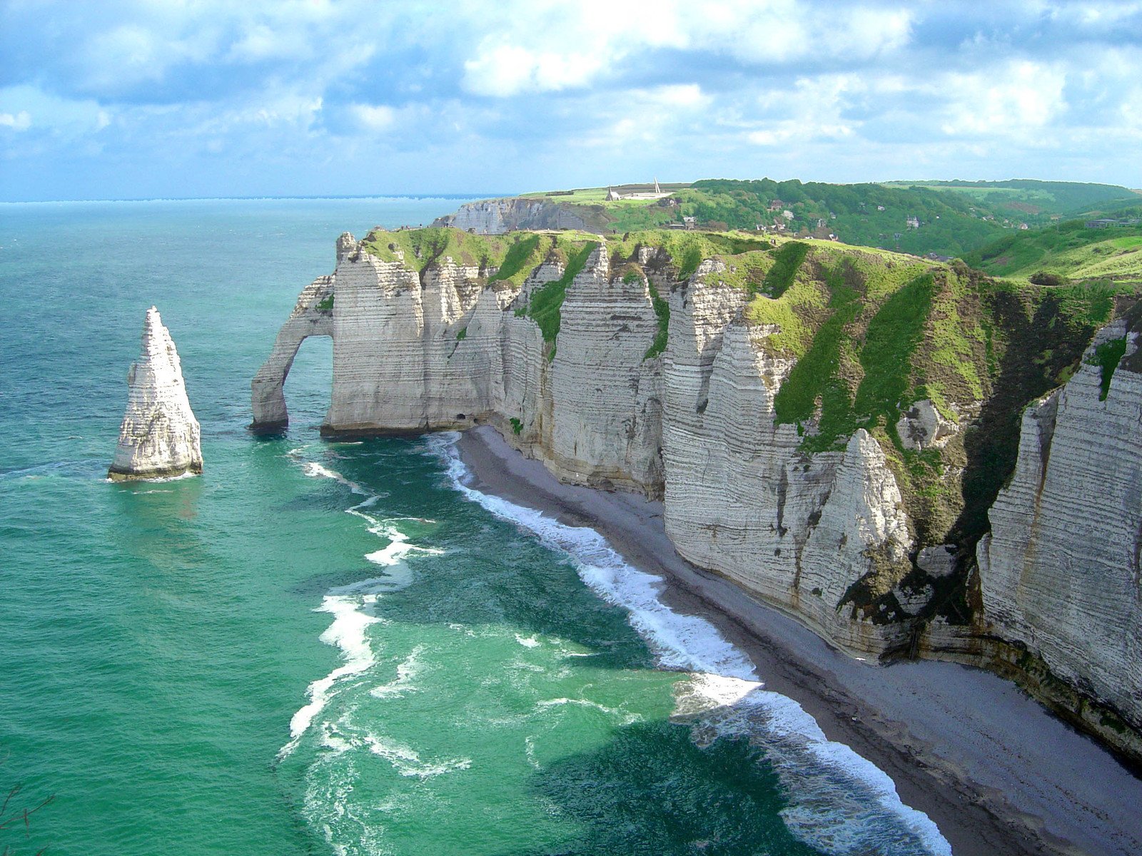 an aerial view of a very rocky cliffside area with a body of water near the cliff side