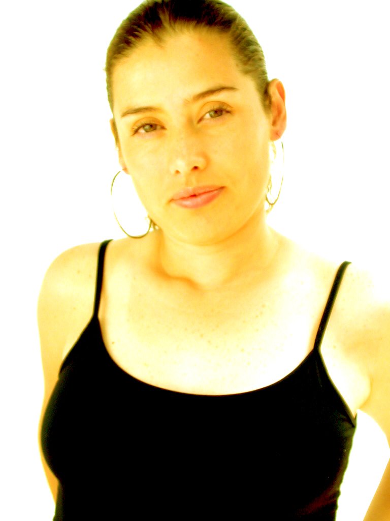 woman in black top in front of white backdrop