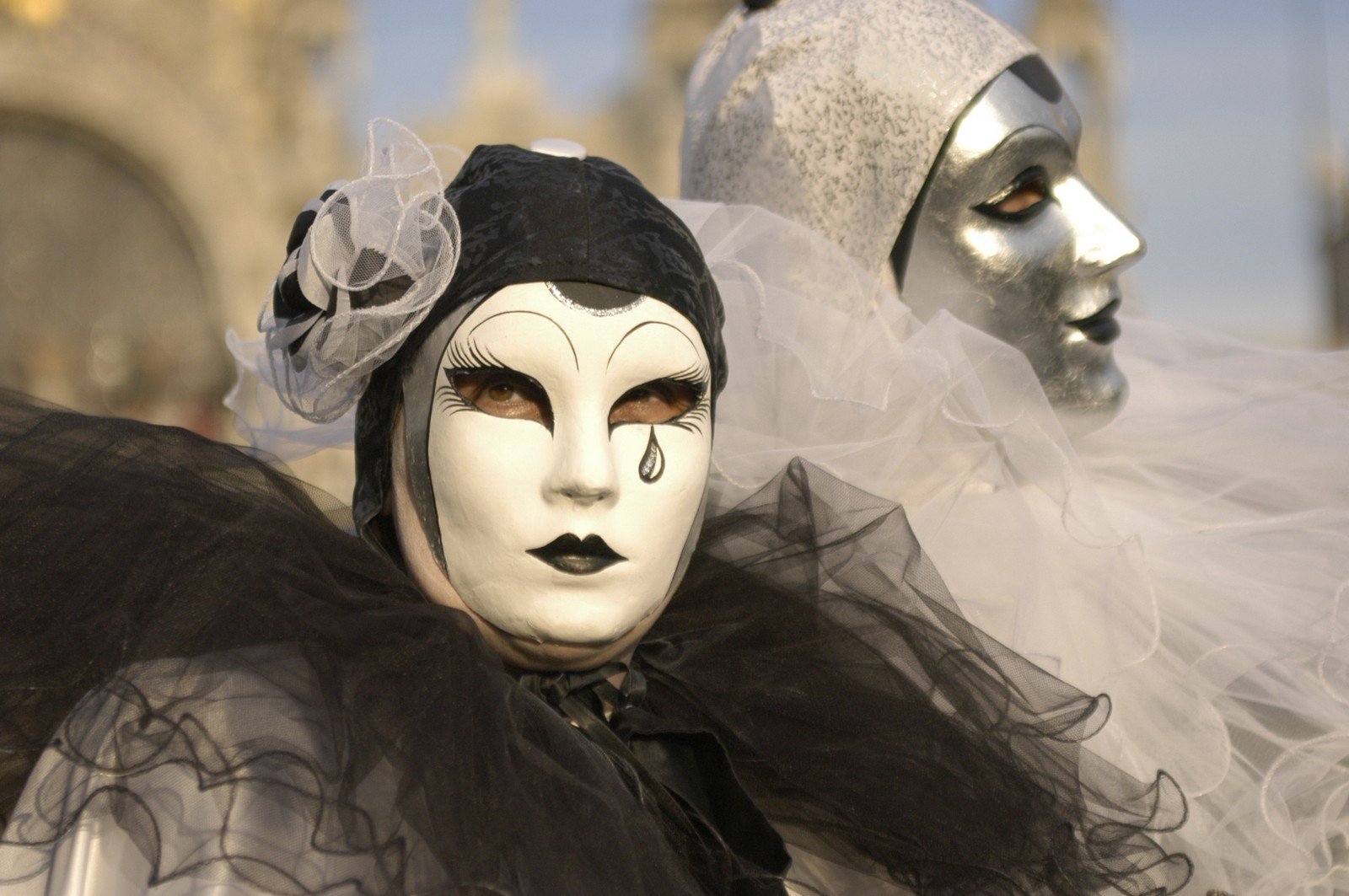 masks are wearing in a parade outside a building