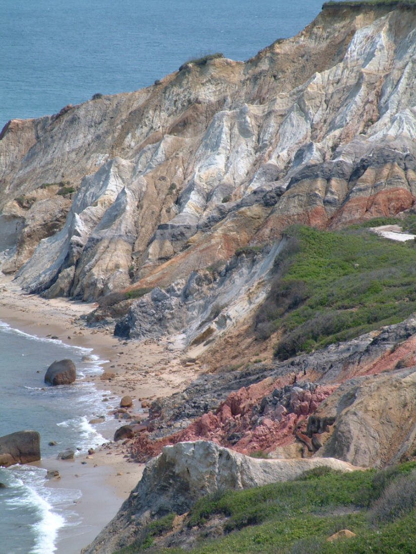 an image of the beach at a rocky cliff