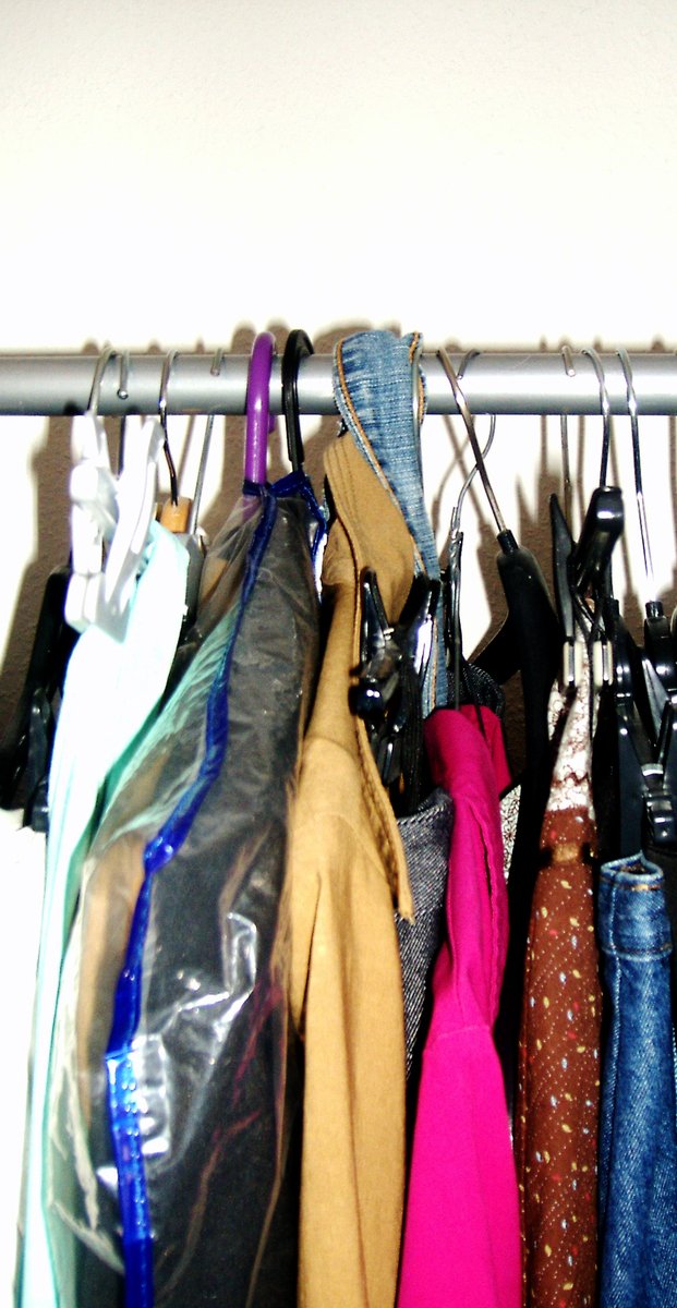 a rack holding some ties, purses and other purses