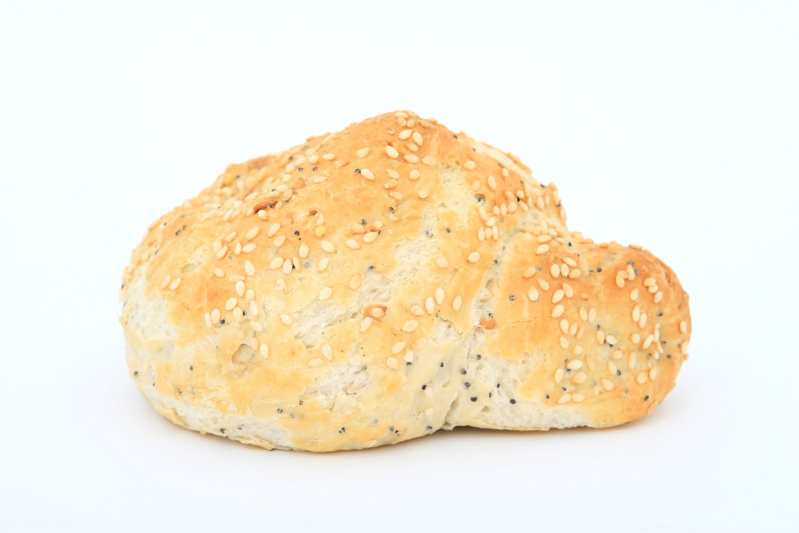 two sesame seed buns laying side by side on top of each other