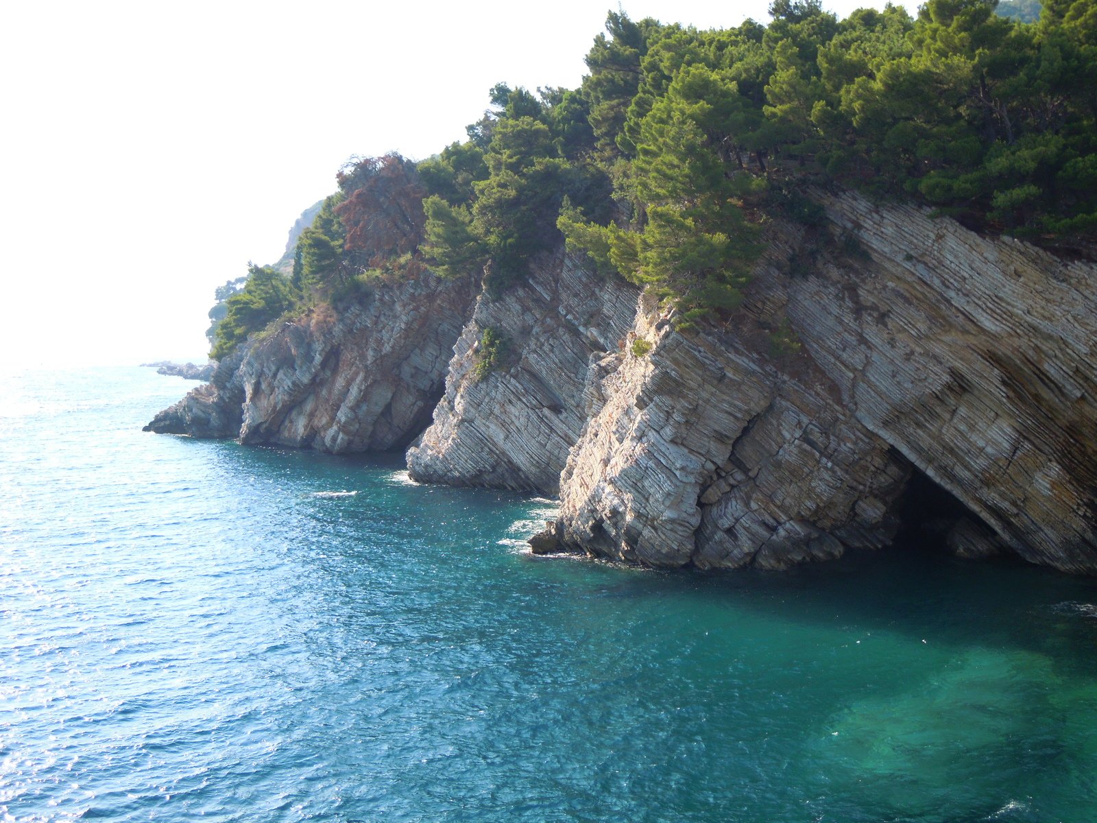 an ocean view with rocks on one side and water in the other