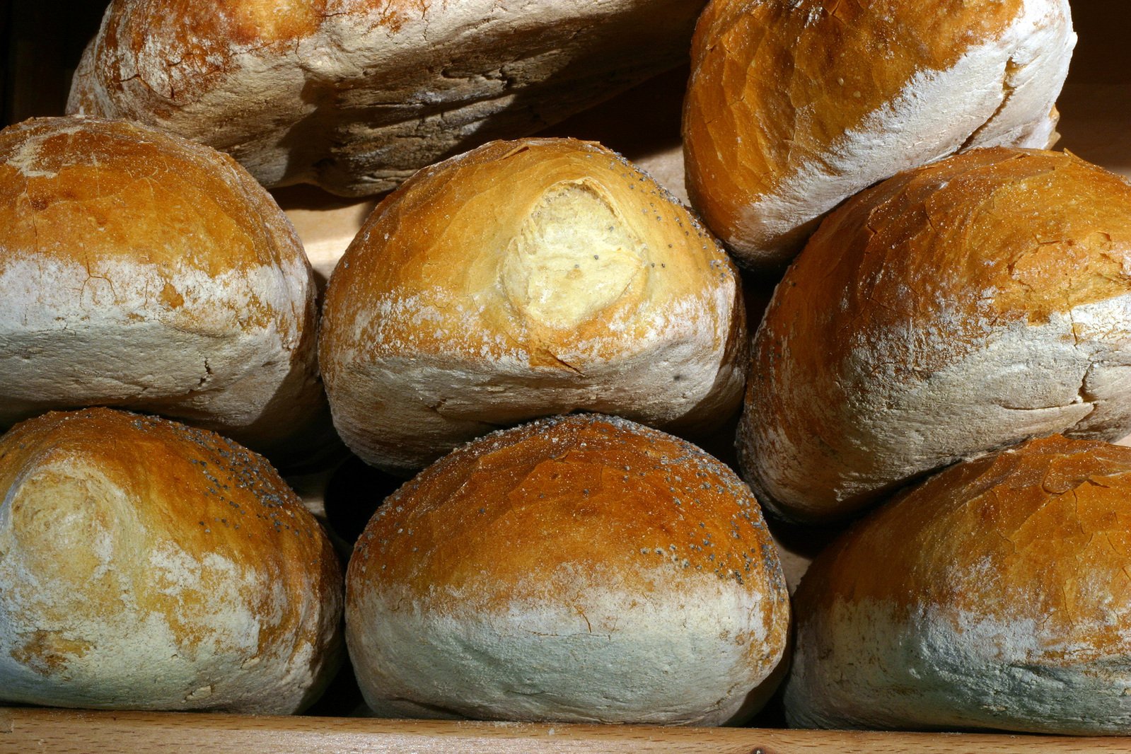 some big round bread loaves piled on top of each other