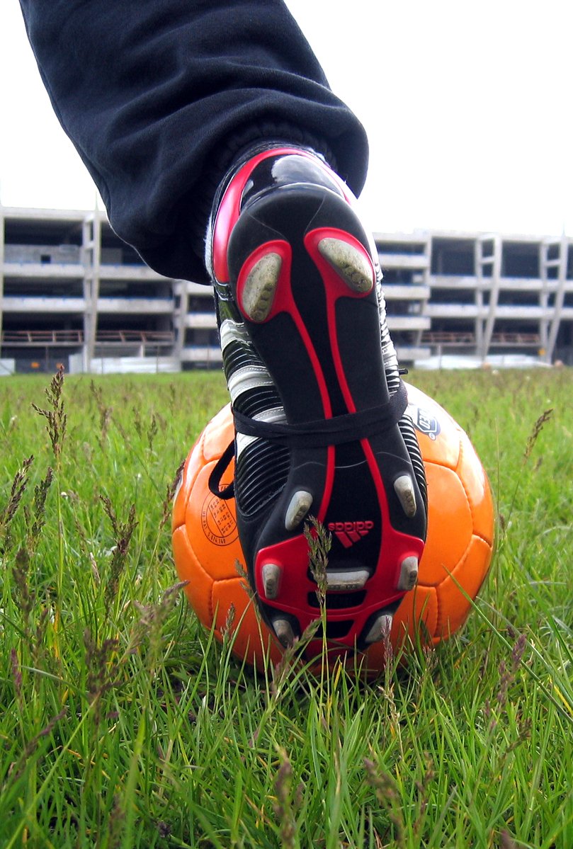 a close up of the foot and feet of a soccer ball