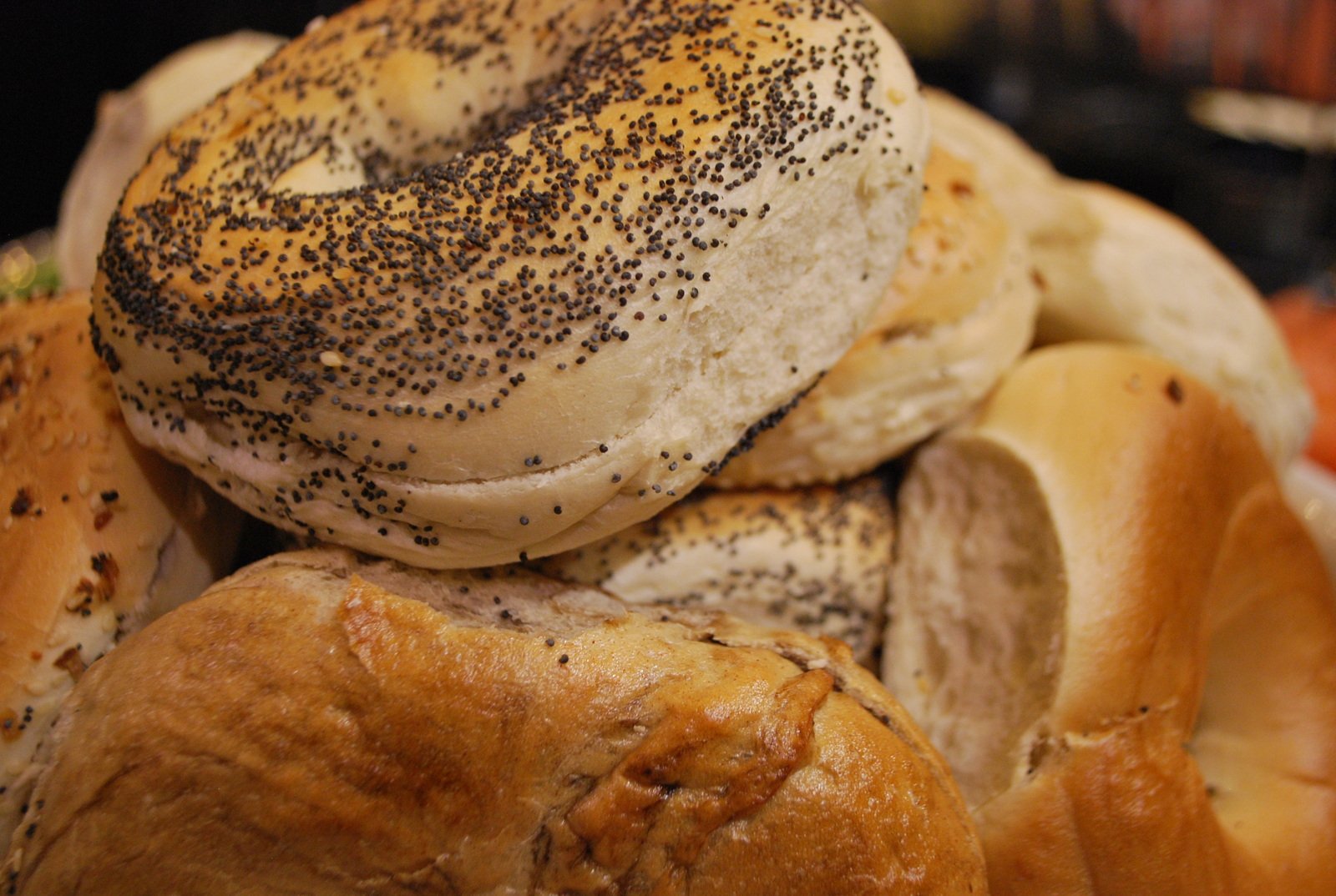 many bagels piled up with a donut in the center