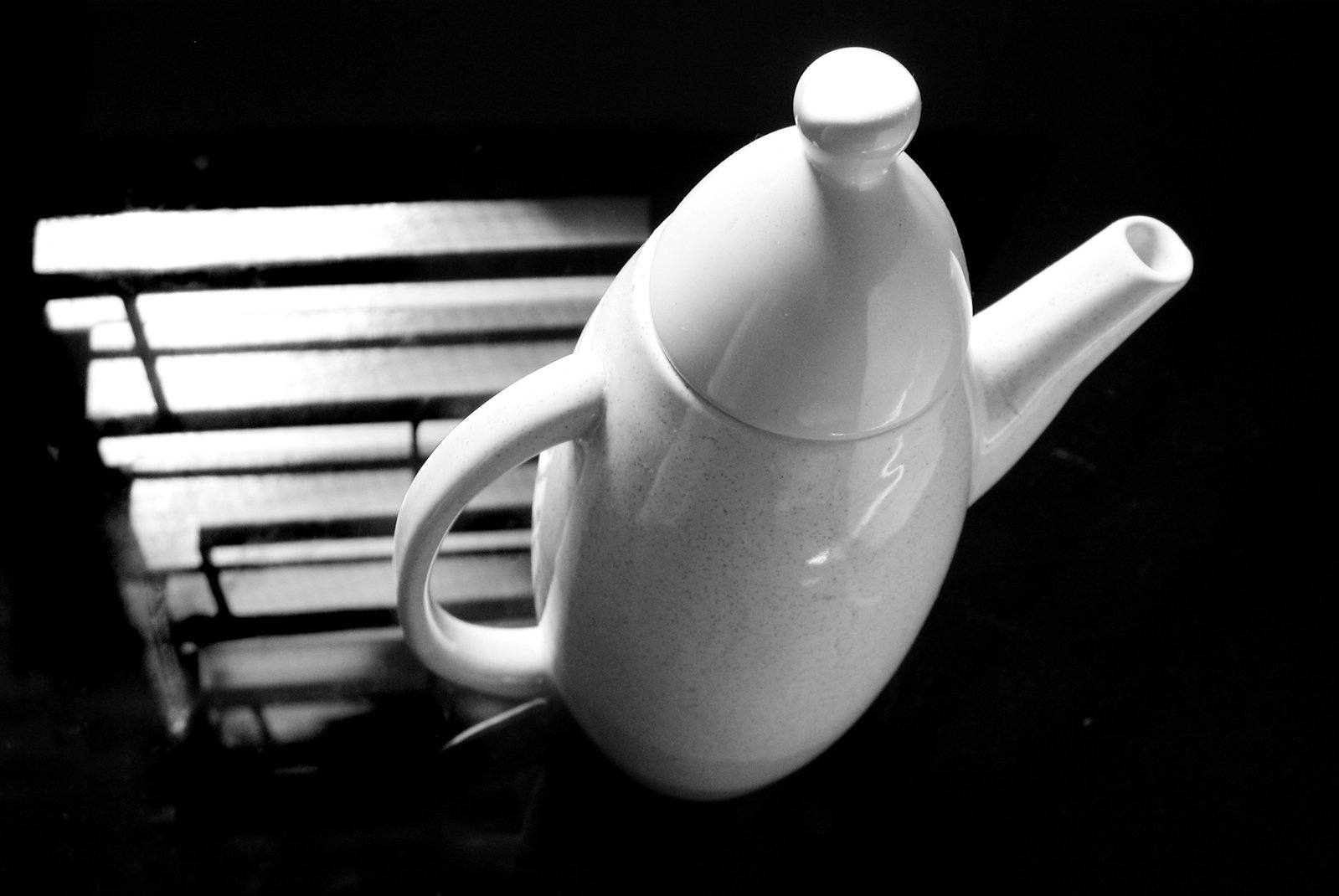 a black and white po of a tea pot sitting on a table