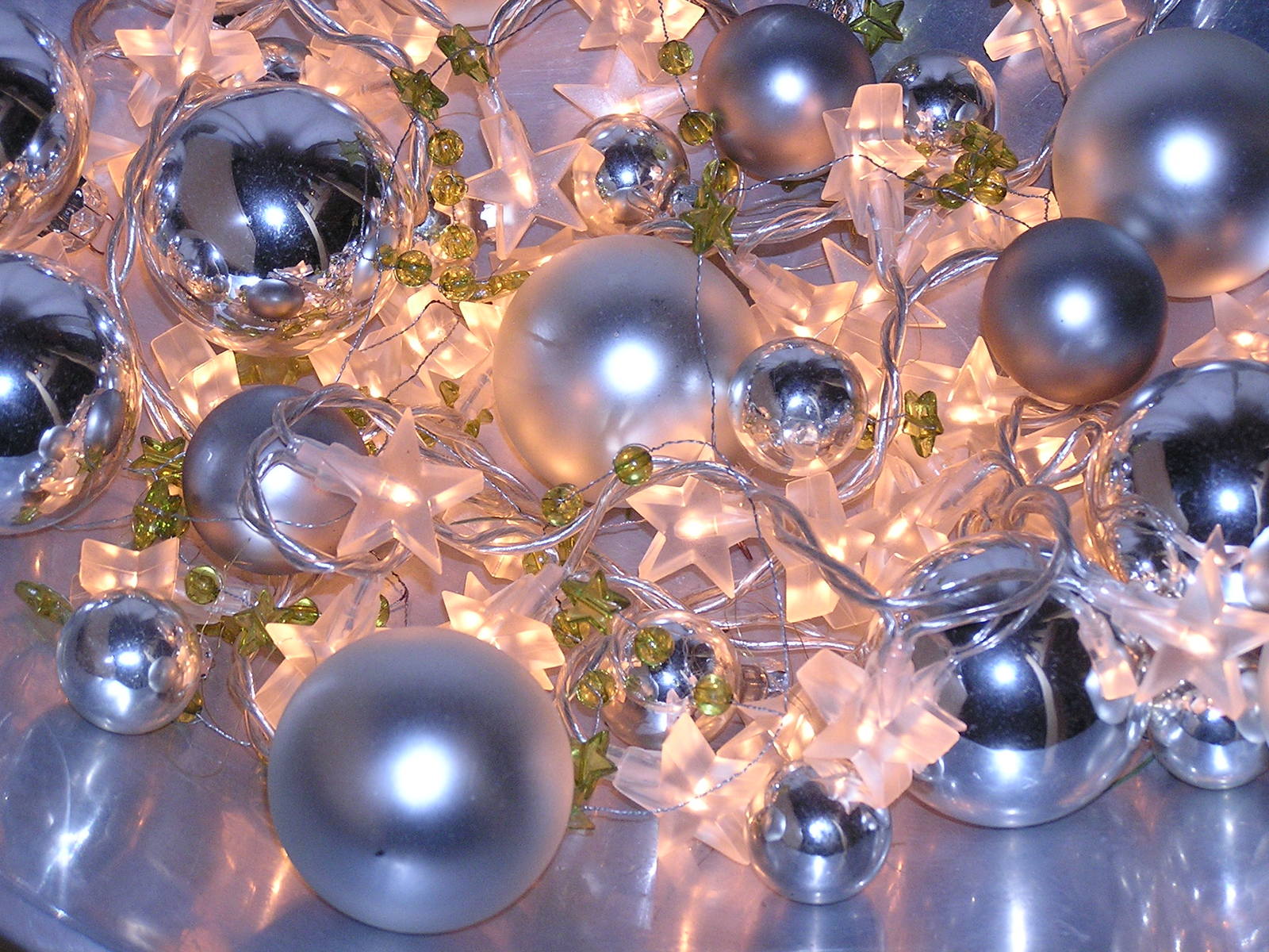 an assortment of silver ornaments on a tray