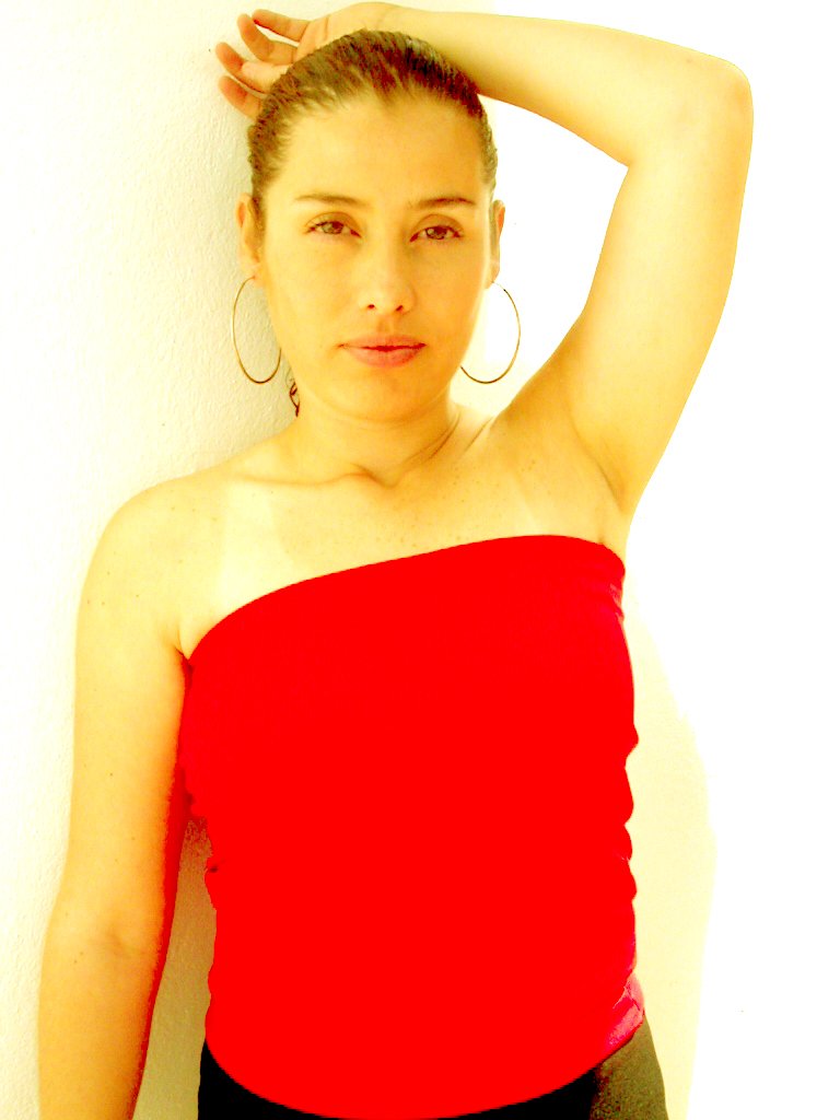 a young woman in a red shirt has her hair in the air