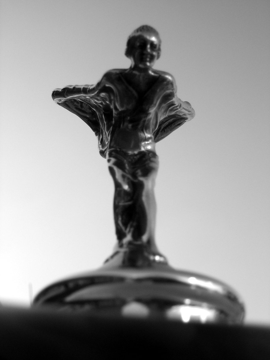 black and white pograph of a figurine on top of a table