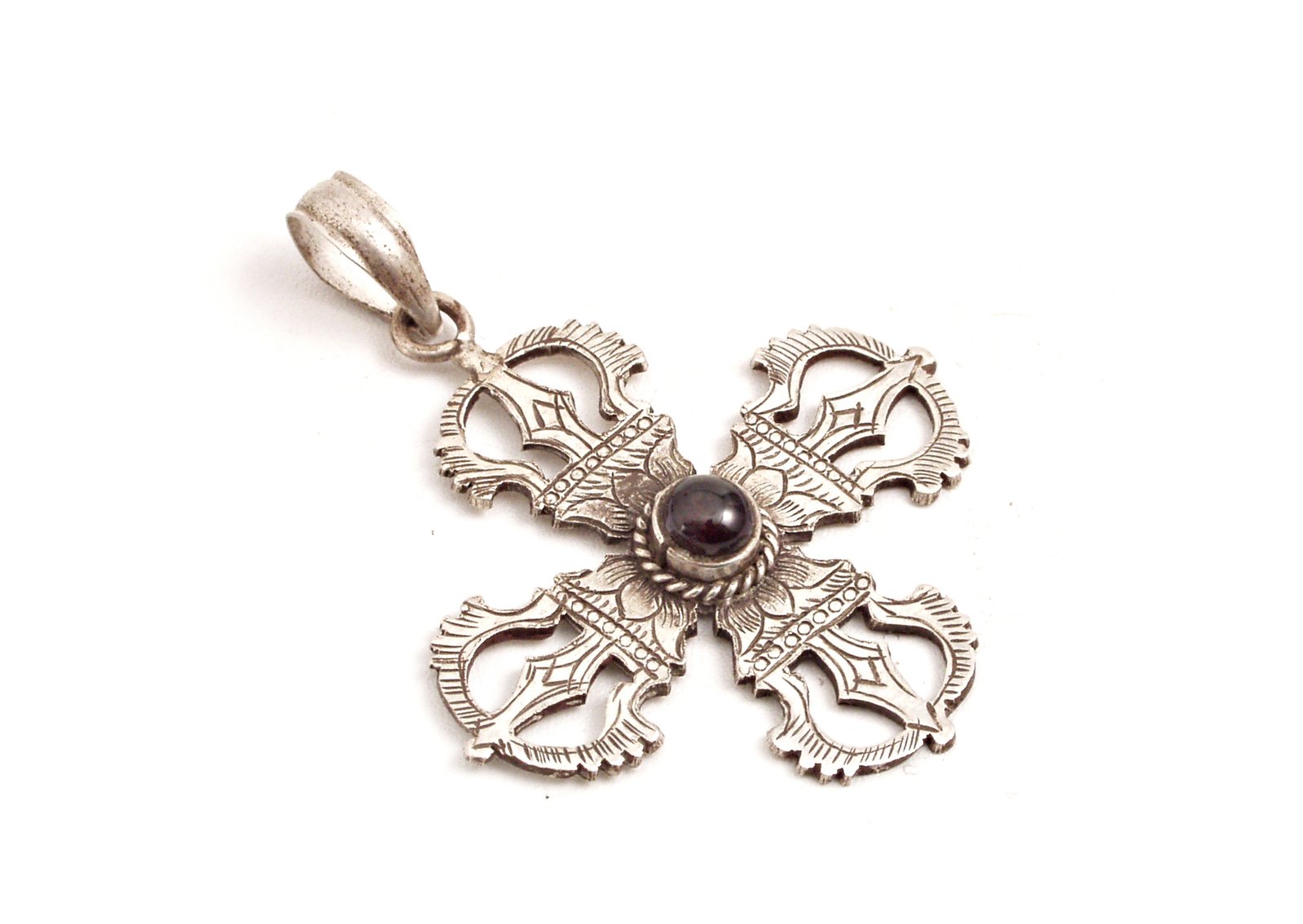 silver pendant with a flower in the middle