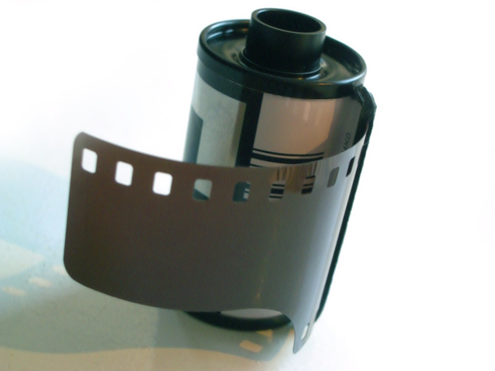 a movie reel attached to an aluminum camera roll