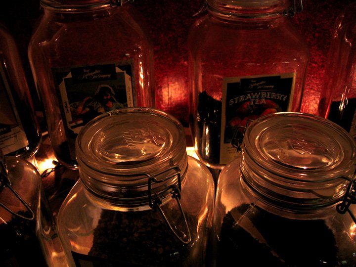a shelf filled with jars and candles on top of each other