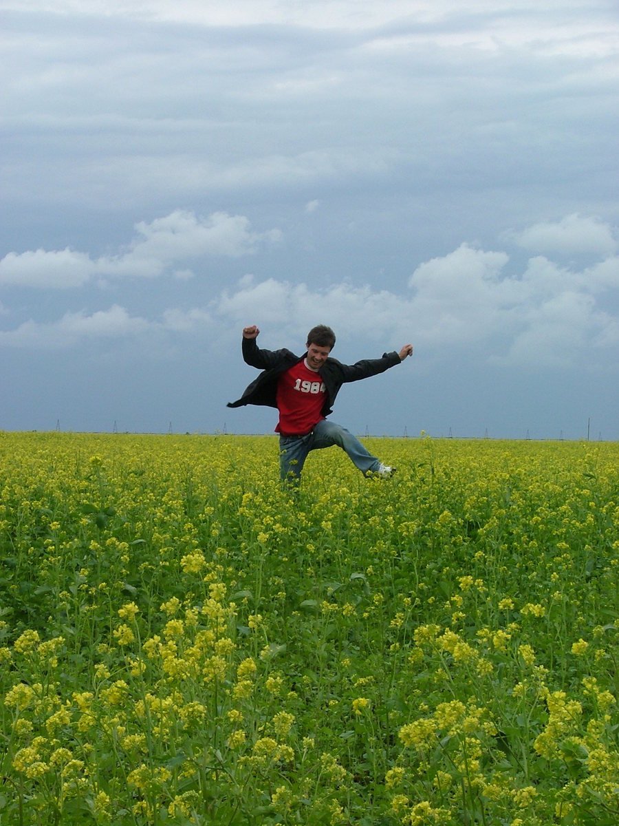 a person in a field with arms up in the air